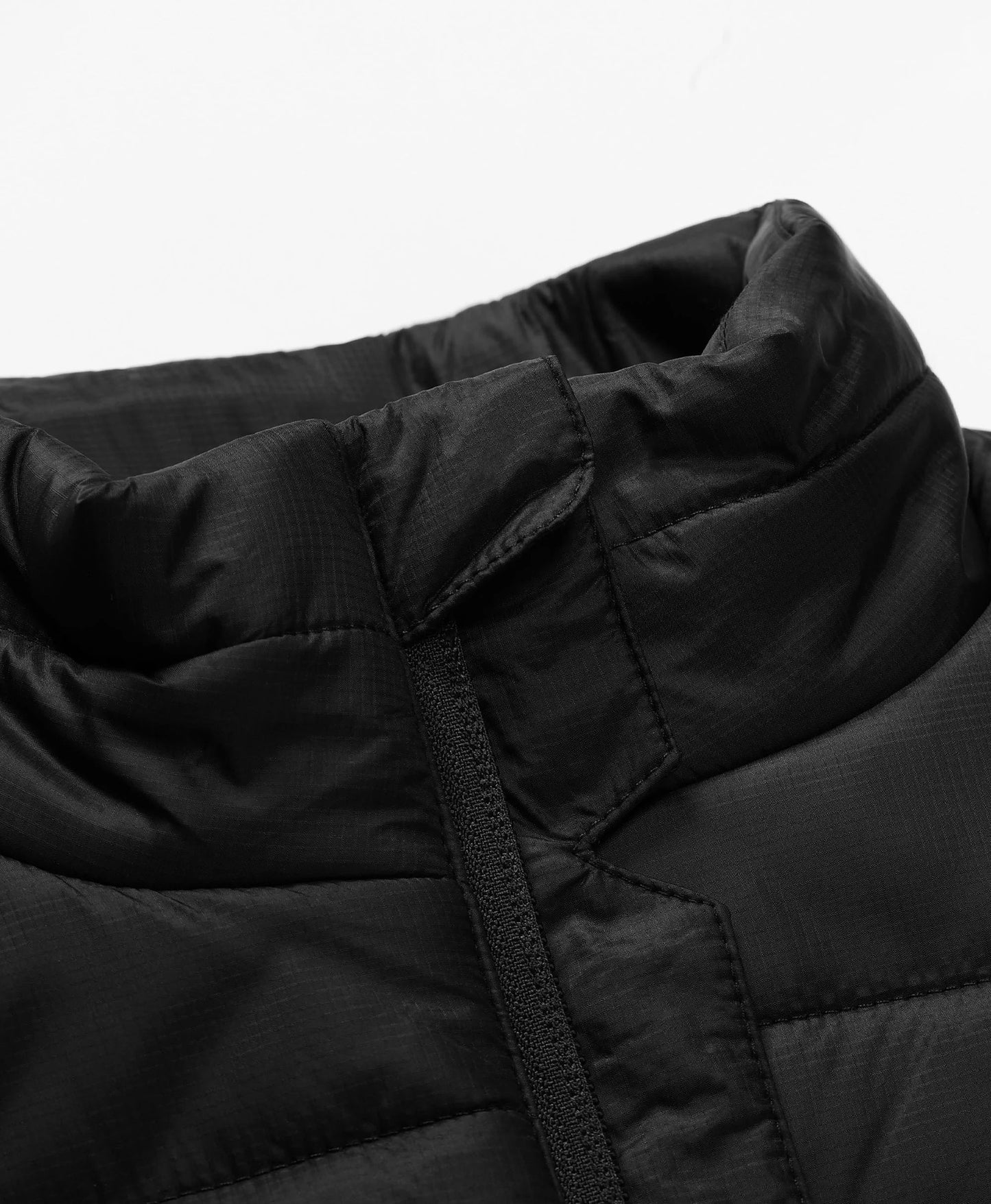 Full-zip vest with a zip-through, stand-up collar for added versatility and warmth.