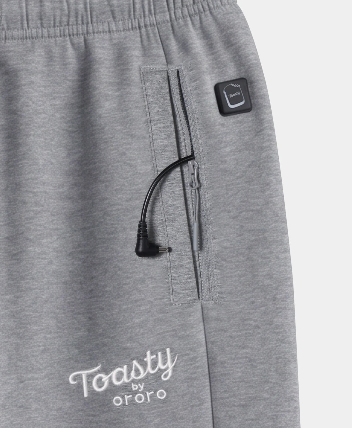 Close-up of Flecking Gray Toasty Heated Sweatpants showing side pocket, power button, and Toasty by ororo logo